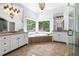 Bright bathroom with a tub, granite countertops, and forest views from multiple windows at 310 Anders Path, Marietta, GA 30064