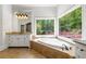 Elegant bathroom with a soaking tub nestled beneath scenic windows with forested views at 310 Anders Path, Marietta, GA 30064