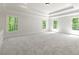 Bright bedroom boasts neutral carpeting, tray ceiling and large windows providing natural light at 310 Anders Path, Marietta, GA 30064