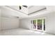 Spacious bedroom featuring plush carpet, a tray ceiling, and a private balcony at 310 Anders Path, Marietta, GA 30064