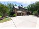 An estate featuring a two-car garage and pristine driveway bordered by mature landscaping at 310 Anders Path, Marietta, GA 30064
