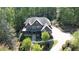 Stunning brick home with a stone facade and charming covered front porch, nestled among mature trees on a beautifully landscaped lot at 310 Anders Path, Marietta, GA 30064