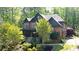 Beautiful home exterior with a stone facade, lush landscaping, and elegant architectural details at 310 Anders Path, Marietta, GA 30064