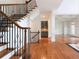 Elegant staircase featuring wrought iron details, hardwood floors, and views of the living space at 310 Anders Path, Marietta, GA 30064