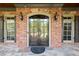 Elegant double front doors, brick exterior, and stylish light fixtures for great curb appeal at 310 Anders Path, Marietta, GA 30064