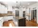 Spacious kitchen with white cabinets, granite countertops, stainless steel appliances, and a center island at 310 Anders Path, Marietta, GA 30064