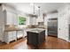 Well-appointed kitchen featuring white cabinetry, granite countertops, stainless steel appliances, and a center island at 310 Anders Path, Marietta, GA 30064