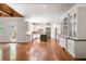 Large kitchen featuring an island, white cabinets, stainless steel appliances, and a hardwood floor at 310 Anders Path, Marietta, GA 30064