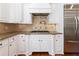Close up view of kitchen with custom hood, and stainless steel appliances at 310 Anders Path, Marietta, GA 30064