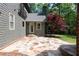 A stone patio with steps leading to the home's entrance, surrounded by lush greenery and the home's exterior at 310 Anders Path, Marietta, GA 30064