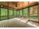 Screened-in porch overlooking lush greenery, providing a serene outdoor space at 310 Anders Path, Marietta, GA 30064