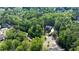 Aerial view showcasing the property lines of a lush, wooded lot featuring a beautiful home with a private driveway at 310 Anders Path, Marietta, GA 30064