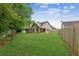 Spacious backyard with well-maintained lawn and wooden fence, perfect for outdoor activities and entertaining at 672 Bostonian Way, Lawrenceville, GA 30046