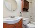 Bathroom featuring a white vanity and large round mirror and a shower/tub combo at 672 Bostonian Way, Lawrenceville, GA 30046