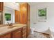 Well-lit bathroom features a large vanity with ample storage, toilet, and framed window at 672 Bostonian Way, Lawrenceville, GA 30046