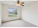 Bright bedroom with plush carpeting, ceiling fan, and large window offering plenty of natural light at 672 Bostonian Way, Lawrenceville, GA 30046