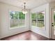 Bright breakfast nook features hardwood floors and large windows offering backyard views at 672 Bostonian Way, Lawrenceville, GA 30046