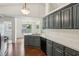 Kitchen featuring blue-gray cabinets, white countertops, black appliances, and hardwood floors at 672 Bostonian Way, Lawrenceville, GA 30046