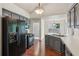 Spacious kitchen featuring hardwood floors, blue-gray cabinets, and black appliances at 672 Bostonian Way, Lawrenceville, GA 30046