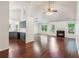 Open-concept living area featuring a fireplace, hardwood floors, vaulted ceiling, and neutral paint at 672 Bostonian Way, Lawrenceville, GA 30046