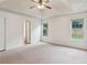 Spacious main bedroom features neutral carpeting, lighted ceiling fan and bright natural light at 672 Bostonian Way, Lawrenceville, GA 30046