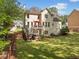 Well-maintained backyard with a large deck, lush green lawn, mature trees, and a fenced perimeter at 1126 Gate Post Ct, Powder Springs, GA 30127