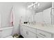 Bright bathroom featuring a white vanity with a stone countertop, modern fixtures, and neutral walls at 1126 Gate Post Ct, Powder Springs, GA 30127
