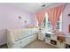 Cozy bedroom features a bed, carpet and a window with pink curtains at 1126 Gate Post Ct, Powder Springs, GA 30127