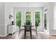 Bright breakfast nook features a table set, tile floors, a view of the backyard and a door to the outside at 1126 Gate Post Ct, Powder Springs, GA 30127