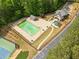 Aerial view showcases the community pool area with a large pool, clubhouse, and green spaces at 1126 Gate Post Ct, Powder Springs, GA 30127