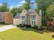 Inviting two-story home with a manicured lawn, stone accents, and a two-car garage at 1126 Gate Post Ct, Powder Springs, GA 30127