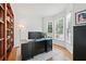 Bright home office with hardwood floors, built-in shelving, and a large window at 1126 Gate Post Ct, Powder Springs, GA 30127