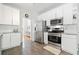 White kitchen featuring stainless steel appliances, tile flooring, and ample cabinet space at 1126 Gate Post Ct, Powder Springs, GA 30127