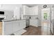 Modern kitchen with white cabinets, stainless steel appliances and countertops, and tile flooring at 1126 Gate Post Ct, Powder Springs, GA 30127