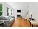 Bright living room with hardwood floors, fireplace, gray couch and large windows at 1126 Gate Post Ct, Powder Springs, GA 30127