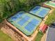 Community tennis courts offer residents an athletic amenity surrounded by trees and landscaping at 1126 Gate Post Ct, Powder Springs, GA 30127