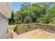 Outdoor wooden deck with backyard lawn and bordering trees at 1281 Snapfinger Rd, Decatur, GA 30032