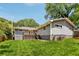 Charming backyard with a lush lawn, wooden deck, and gray siding, perfect for outdoor relaxation and entertaining at 1281 Snapfinger Rd, Decatur, GA 30032