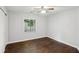 Charming bedroom showcasing hardwood floors, a ceiling fan, and a window with serene outdoor views at 1281 Snapfinger Rd, Decatur, GA 30032