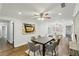 Dining room with hardwood floors, a ceiling fan, and an open layout to living spaces at 1281 Snapfinger Rd, Decatur, GA 30032