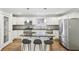 Stylish kitchen featuring white cabinets, granite counters, stainless steel appliances, and breakfast bar seating at 1281 Snapfinger Rd, Decatur, GA 30032