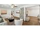 Living room with stone fireplace, wood floors, and an open layout to adjacent rooms at 1281 Snapfinger Rd, Decatur, GA 30032