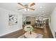 Open-concept living area with stone fireplace, ceiling fan, and hardwood floors leading to dining at 1281 Snapfinger Rd, Decatur, GA 30032