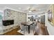Inviting open concept living room with stone fireplace, dining area, and modern kitchen, perfect for entertaining at 1281 Snapfinger Rd, Decatur, GA 30032
