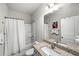 Bright bathroom with a granite countertop, tile floor, and shower over tub at 2450 Norwood Park Xing, Atlanta, GA 30340