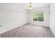 Neutral bedroom with carpeted floors, window, and a simple light fixture at 2450 Norwood Park Xing, Atlanta, GA 30340