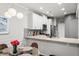 Bright dining area with white cabinets, granite countertops, and a modern pendant light at 2450 Norwood Park Xing, Atlanta, GA 30340