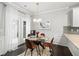 Dining room featuring a glass table, modern light fixture, and view to the outside at 2450 Norwood Park Xing, Atlanta, GA 30340