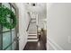 Inviting home foyer with hardwood floors, wainscoting, and stairs leading to the upper level at 2450 Norwood Park Xing, Atlanta, GA 30340