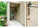 Inviting front entrance with a storm door, brick accents, and attached garage at 2450 Norwood Park Xing, Atlanta, GA 30340